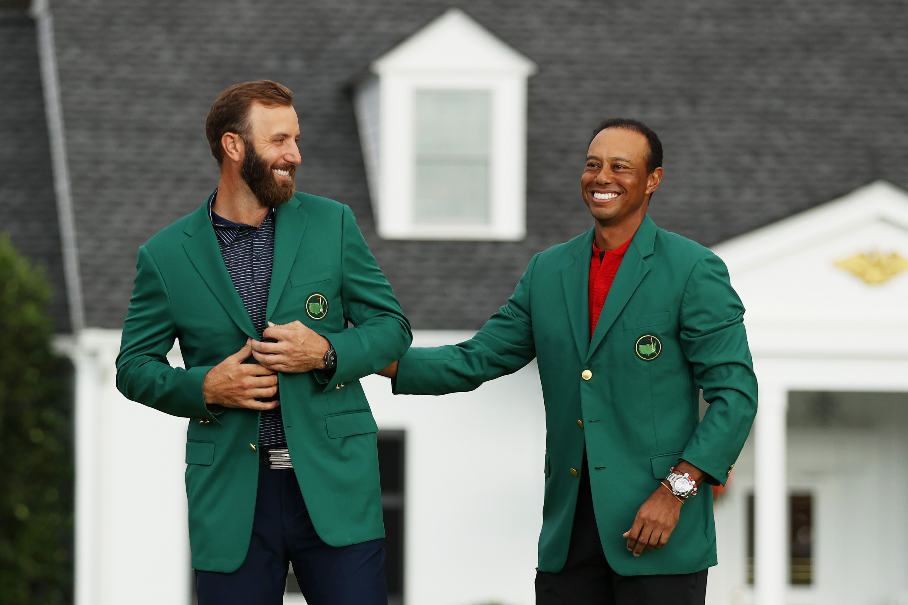 De Amerikaanse topgolfers Dustin Johnson en Tiger Woods na afloop van de Masters op Augusta in 2020